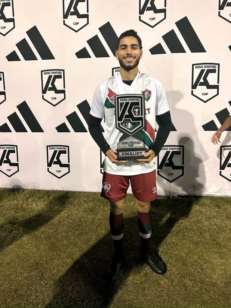 Lucas Lima Policarpo holding a tournament finalist trophy